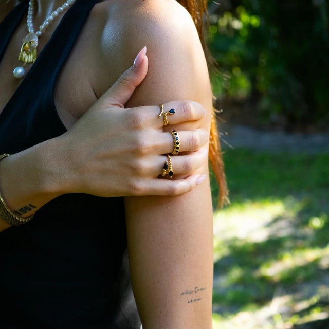 Channel strength and grounding energy with the Black Onyx Teardrop Glow Gold Adjustable Ring. Featuring two bold teardrop-...