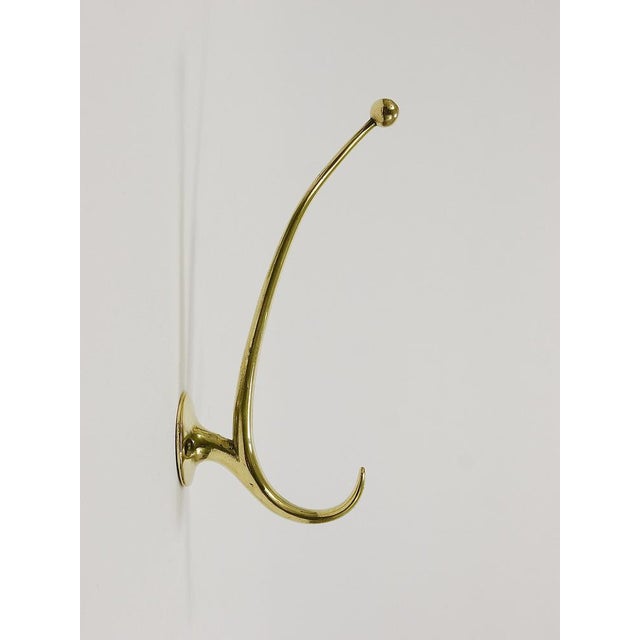 Vintage sleek and elegant Mid-Century wall coat hooks, designed by Franz Hagenauer and crafted by Werkstätte Hagenauer in...