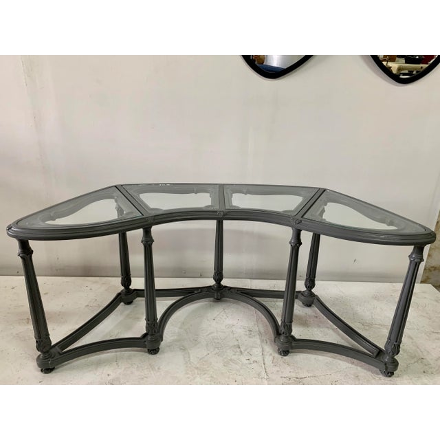 This is a classic Hollywood Regency writing desk with glass inset panels. Dark gray lacquer and a beautiful intricate...