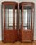 Midcentury pair of Chinese export mirrored back cabinets with brass hardware, thick glass shelving and ample storage....