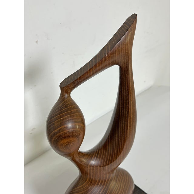 A teak abstract figurative sculpture (23" high) signed with initials H.A, circa 1970s.