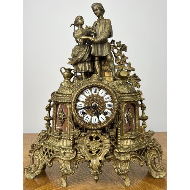 This elegant vintage brass clock is a wonderfully decorative statement piece, featuring an ornate mantel design with...