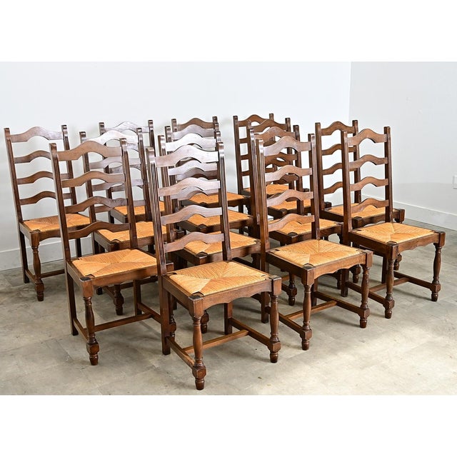 A set of fourteen ladderback and rush seat French side chairs will add classic Provincial style to any dining room....