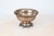 This vintage solid brass pedestal bowl features a scalloped rim, ornate etched detailing, and a rich patina. Substantial...