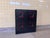 This striking vintage cabinet in brutalist style features a bold and graphic design in black with distinctive red details....