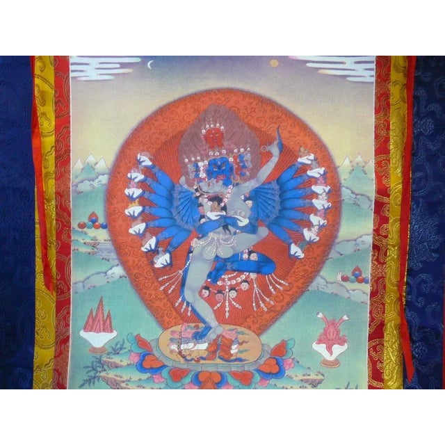 This is a Tibetan Thangka which has a print graphic of Tibetan Buddha or Deity Art at the center and surrounded by...