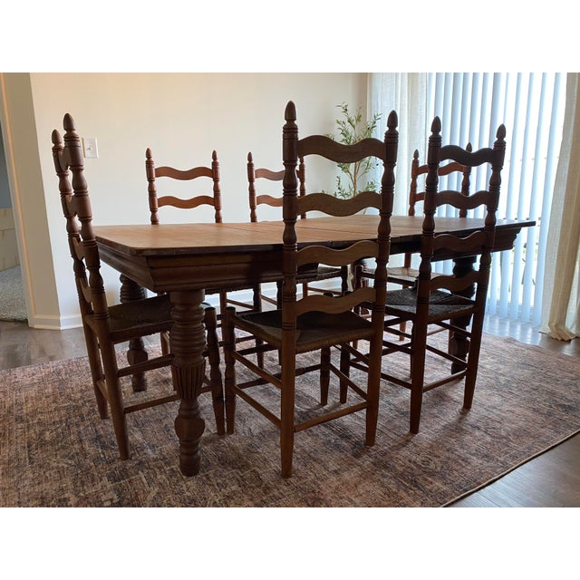 This rare oak table and chair set is over 100 years old. It’s in its original condition and includes extra leaves for...