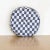 Circular pillow made from vintage blue and white checkered cotton fabric with edge piping and center button detailing.