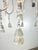 12-light Tuscan style two-tier painted chandelier by Melissa Levinson. It features a multi-tiered design with twelve...
