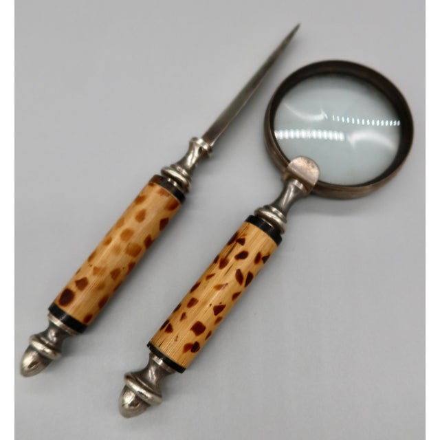 A beautifully matched desk set comprising a magnifying glass and letter opener, each featuring a turned bamboo handle with...