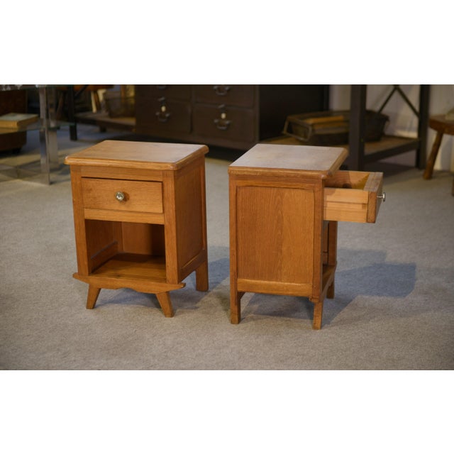 Pair of oak bedside tables, typical of the 1960s, with a simple and well-proportioned design. Each table features a drawer...