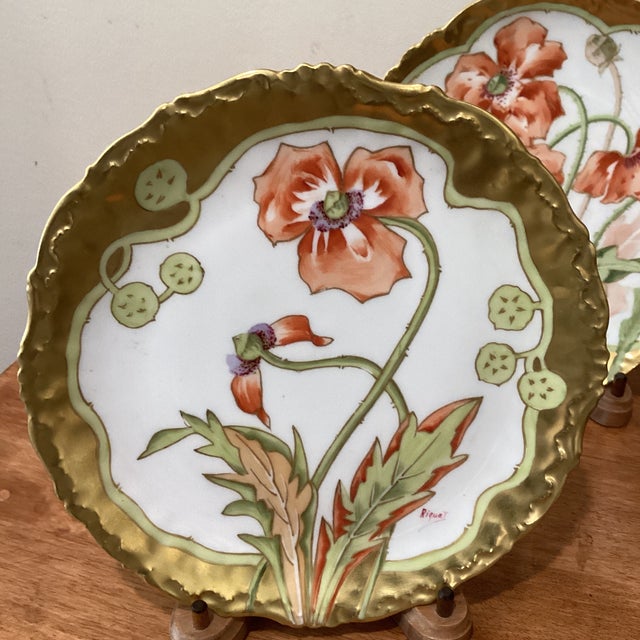 Discover the elegance and artistry of French porcelain with this exquisite pair of Elite Limoges collector plates. Adorned...