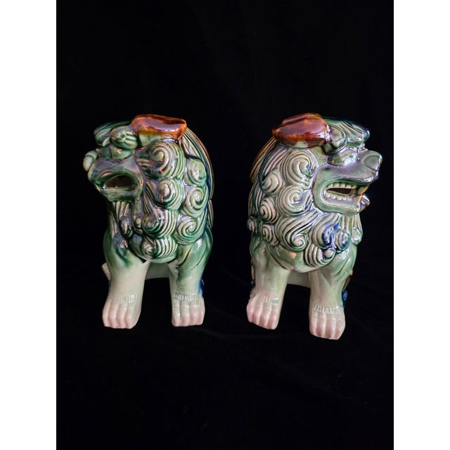 Vintage Mid-Century ceramic Foo Dogs predominantly green with accents of blue, brown and white, no cracks, chips or...