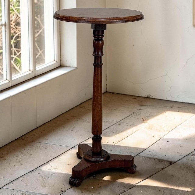 Graceful and finely balanced, this English mahogany gueridon side table features a circular top supported by a beautifully...