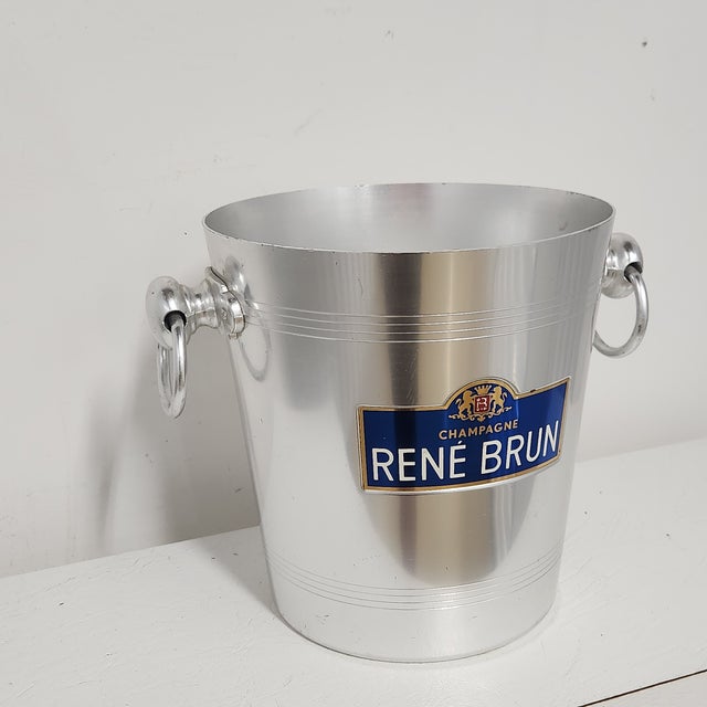 Authentic mid-century French René Brun Champagne ice bucket crafted in sleek brushed aluminum with classic ring side...