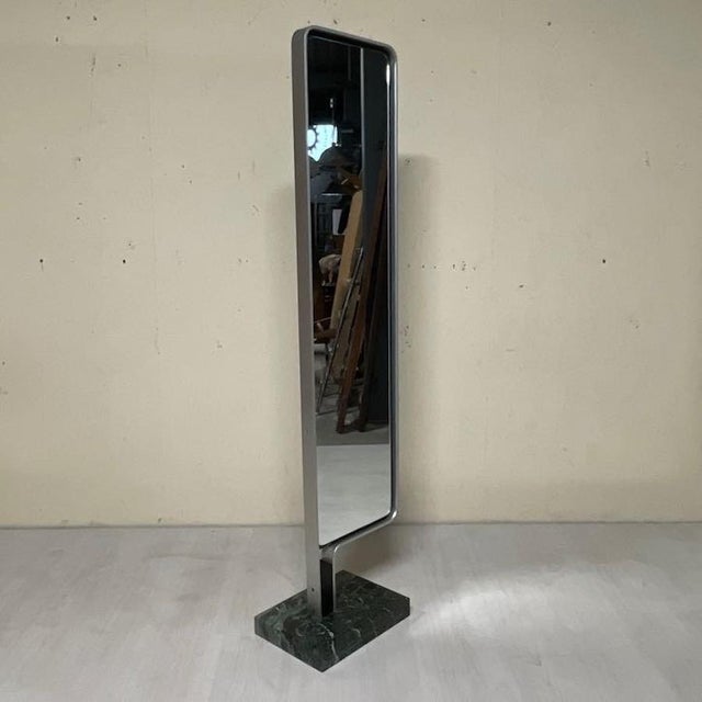 A vintage floor mirror in the 1970s–1980s style, featuring clean lines and sleek proportions typical of Italian design of...