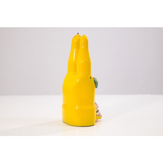 A mixed-media sculpture titled “I’m Not Crazy” by Tim Burke, c. 2000s. The sculpture depicts a stylized yellow figure with...