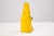 A mixed-media sculpture titled “I’m Not Crazy” by Tim Burke, c. 2000s. The sculpture depicts a stylized yellow figure with...
