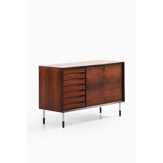 This rare sideboard and bar cabinet, designed by arne vodder and produced by sibast møbelfabrik in denmark during the...