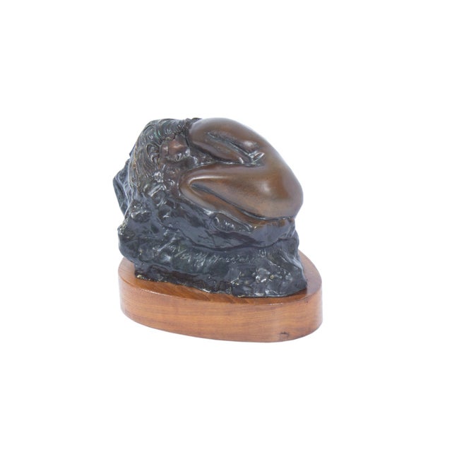 A 1989 bronze sculpture of a woman by the American sculptor, Huberto Maestas. This sculpture features a woman sleeping on...