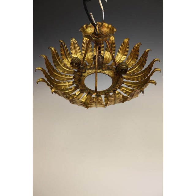 Mid-century spanish sunburst ceiling light in gilt iron, c.1950s a striking mid-century spanish sunburst ceiling light,...