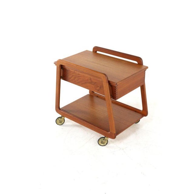A functional and aesthetic masterpiece from the Danish Mid-Century Modern period. This authentic serving cart was designed...