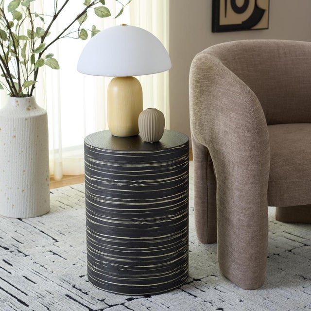 The Bahan End Table introduces a refined and modern wooden piece finished in sophisticated black that elevates any...