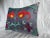 A striking vintage Suzani pillow showcasing bold Central Asian embroidery on a soft charcoal base. The hand-stitched...