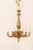 A French six-light carved and gilt wood chandelier from the mid 20th century. This vintage chandelier from France features...