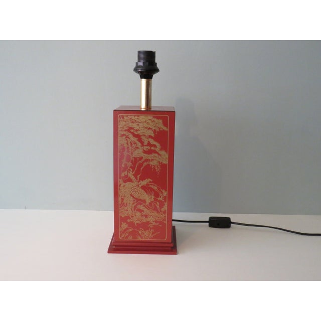 Mid-Century lamp base with oriental motif. The base is made of brown lacquered wood and have on 4 side a golden oriental...