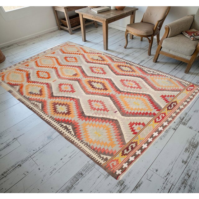 This distinguished vintage kilim from the 1960s represents the authentic textile traditions of the Akdeniz (Mediterranean)...