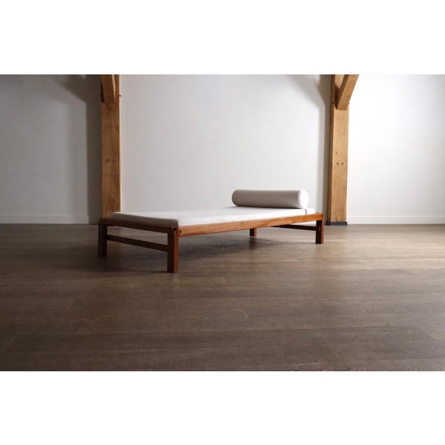 Stunning daybed model l03 in solid elm wood and bouclé by pierre chapo, 1970s. the breathtaking design features the iconic...