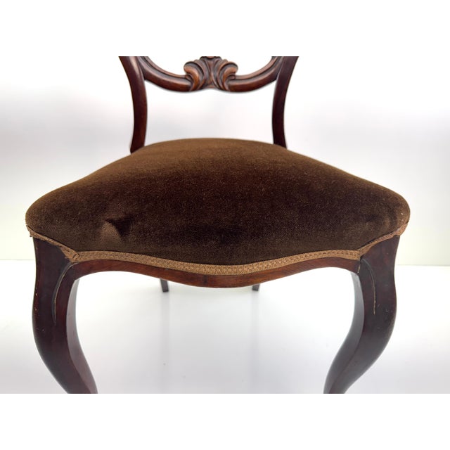 A striking example of Victorian craftsmanship, this balloon-back side chair by T.R. Roberts, Ltd. of Islington, London,...