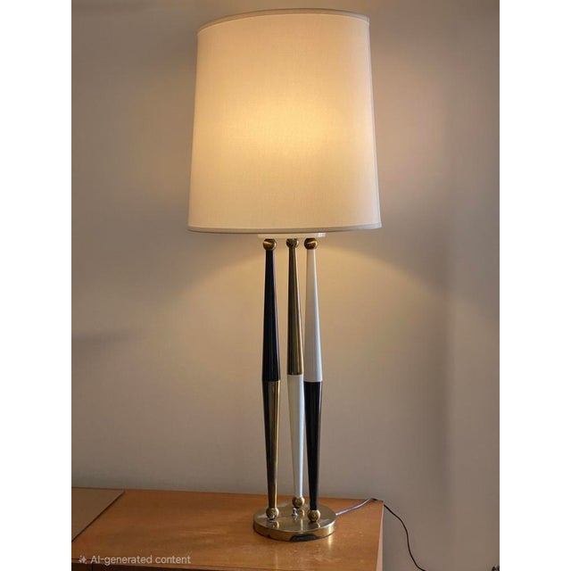Vintage 1980's tall metal table lamp, with a stylish combination of brass, and black and white enamel finishes, along with...