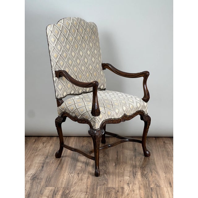 This elegant French arm chair captures the refined curves and carved detailing of the Régence period, blending the...