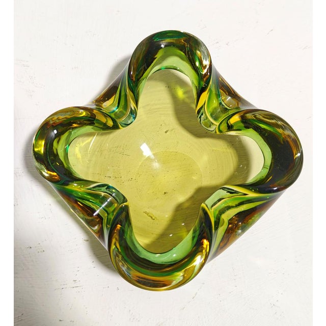 Flavio Poli. Vintage Murano glass ashtray, characterized by green and yellow colors and the sommerso glass technique. Made...