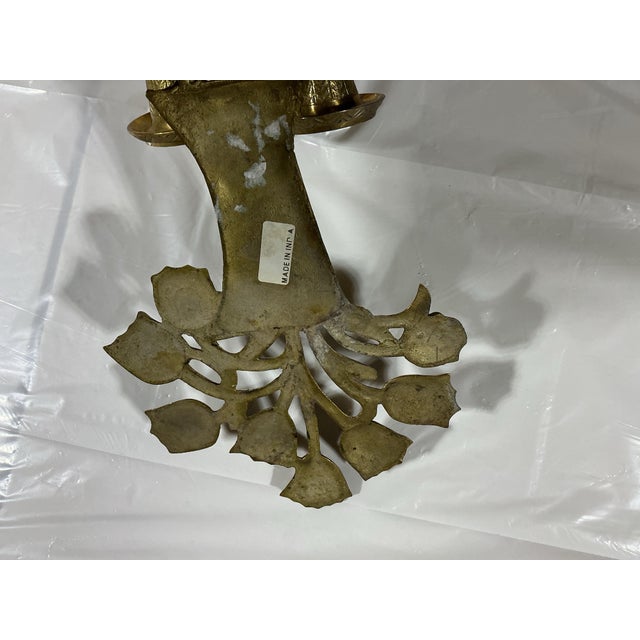 Add warmth and Hollywood Regency flair to your gallery wall or dining room with this solid brass double-arm candle sconce....