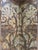 This monumental vintage folding screen features two stylized peacocks as the central motif, surrounded by elaborate...