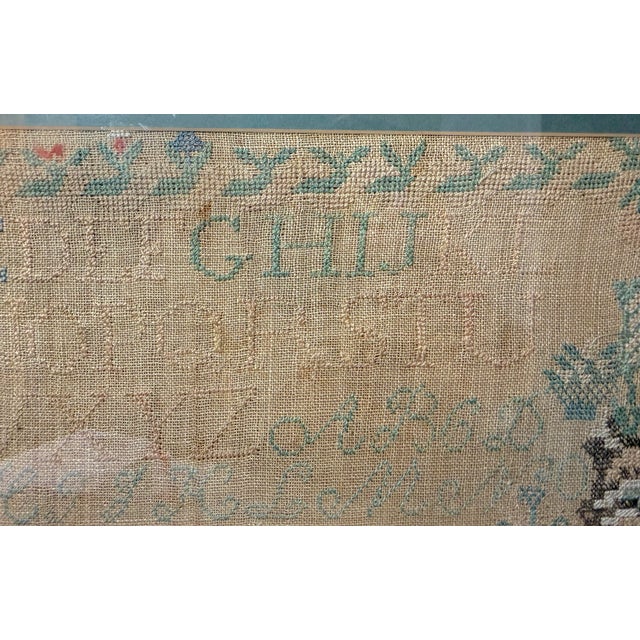 Up for sale is a large antique early 19th century handmade needlepoint sampler. The sampler is done with elaborate...