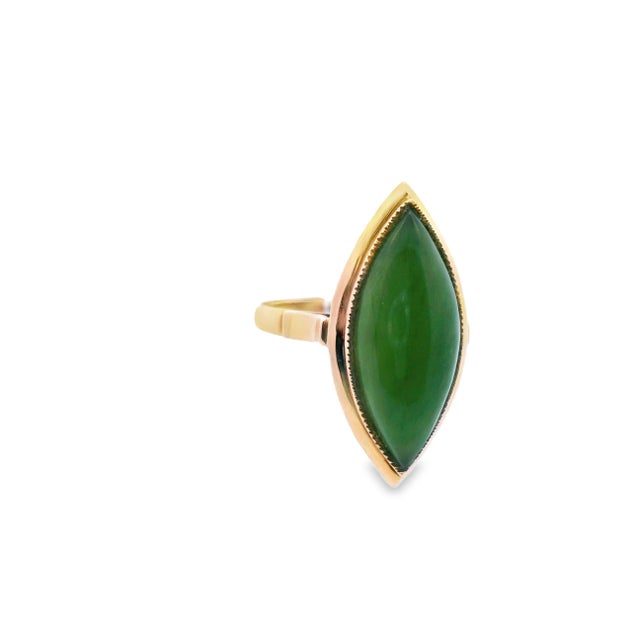 This beautiful 14k yellow gold ring features an exquisite cabochon nephrite jade. The under gallery is constructed with...