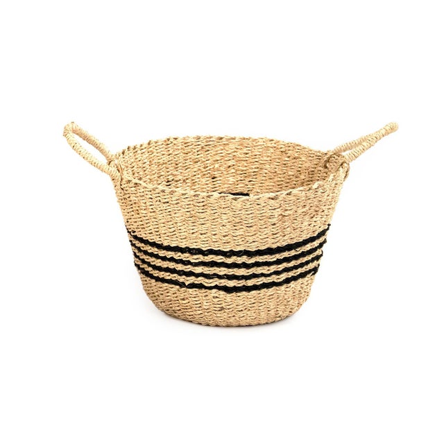 Woven handmade seagrasss basket with a dark brown accent around basket.