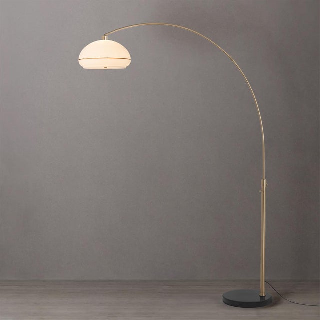 Sleek and modern, the Morelli Simple Arc Floor Lamp features a gracefully curved arm in matte black with weathered brass...