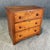 This early 1900s walnut three-drawer chest features warm, well-aged wood with attractive grain, simple round pulls, and a...