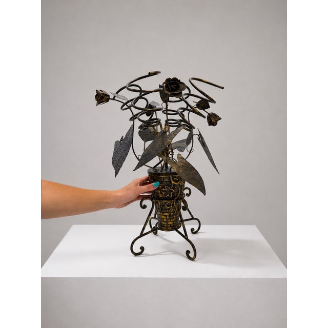 Striking vintage wrought-iron wine rack designed as an elaborate floral bouquet, with curling stems, sculptural roses,...