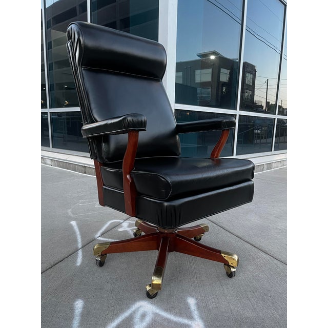 Gunlocke model “Washington” executive desk chair in black leather hardwood maple base having 5-leg brass capped ends with...