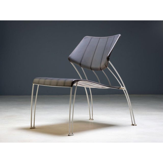 A pair of sculptural shell chairs produced by ikea in the late 1990s–2000s, representing the brand’s move toward sleek,...