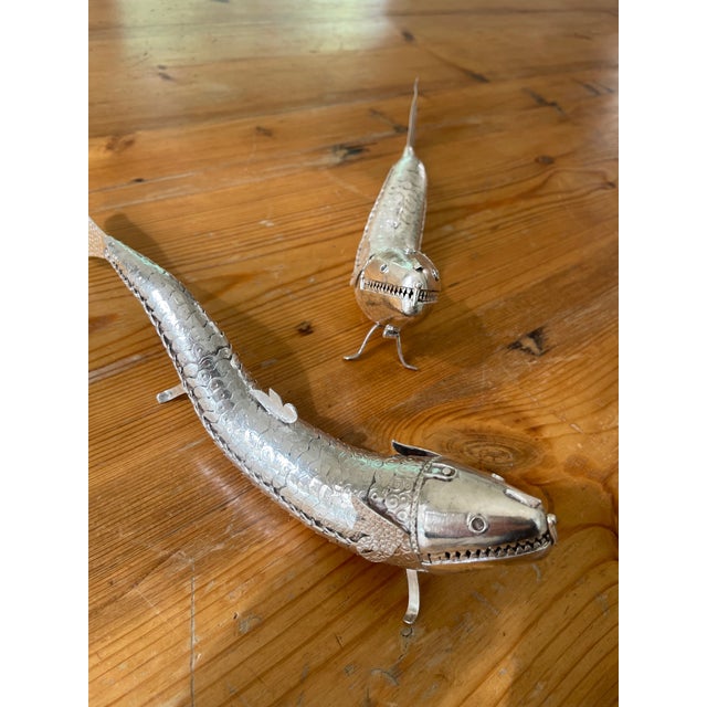 Pair of identical Sterling Silver realistically modeled fish with articulated sections allowing the body to move from side...
