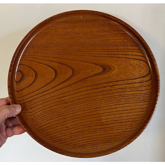 Early 20th century Japanese turned wood round tray with dished rim. Highly figured grain. Measures 11 3/8" diameter x...