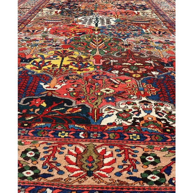 Measures: 7' x 11'6. This magnificent Antique Bakhtiari Rug features an all-over diamond garden design replete in with a...