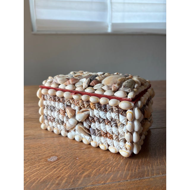 This vintage English trinket box is entirely clad in collected shells — each one thoughtfully hand placed to create a...